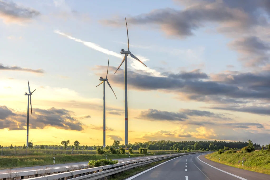 wind turbines sunset road clean energy compressed